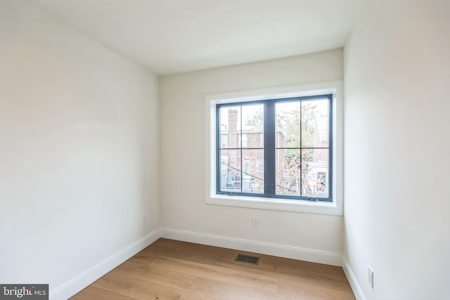 unfurnished room with light hardwood / wood-style flooring