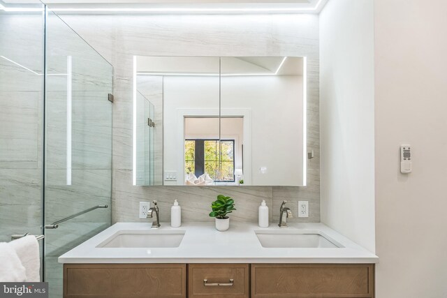 bathroom featuring vanity and tasteful backsplash