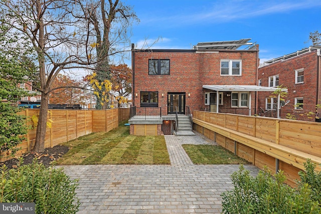 rear view of property featuring a jacuzzi