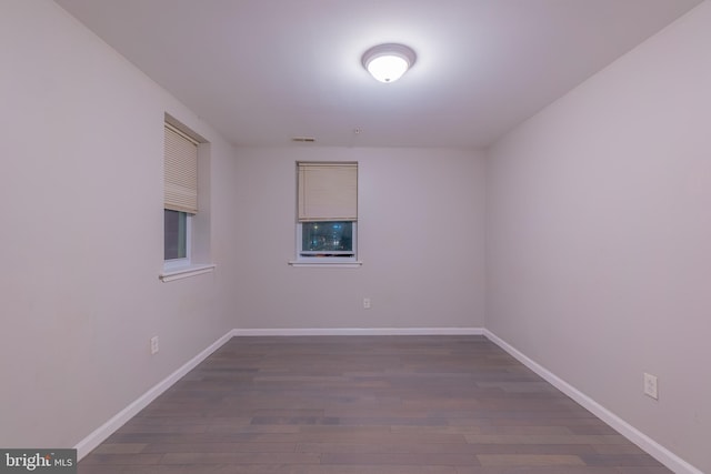 spare room with dark wood-type flooring