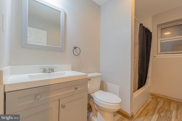 full bathroom with vanity, hardwood / wood-style floors, toilet, and shower / tub combo with curtain