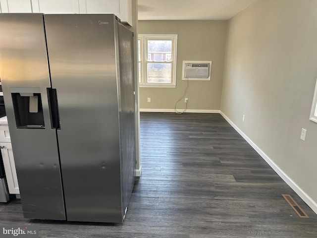 kitchen featuring a wall mounted AC, dark wood-type flooring, stainless steel fridge with ice dispenser, and white cabinetry