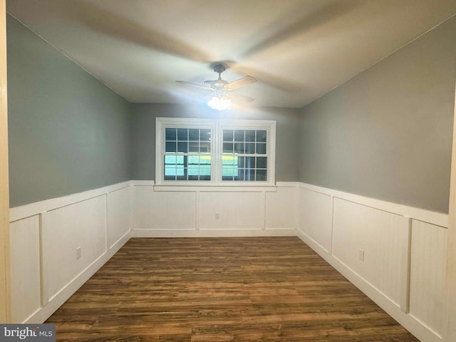 empty room with dark wood-type flooring and ceiling fan