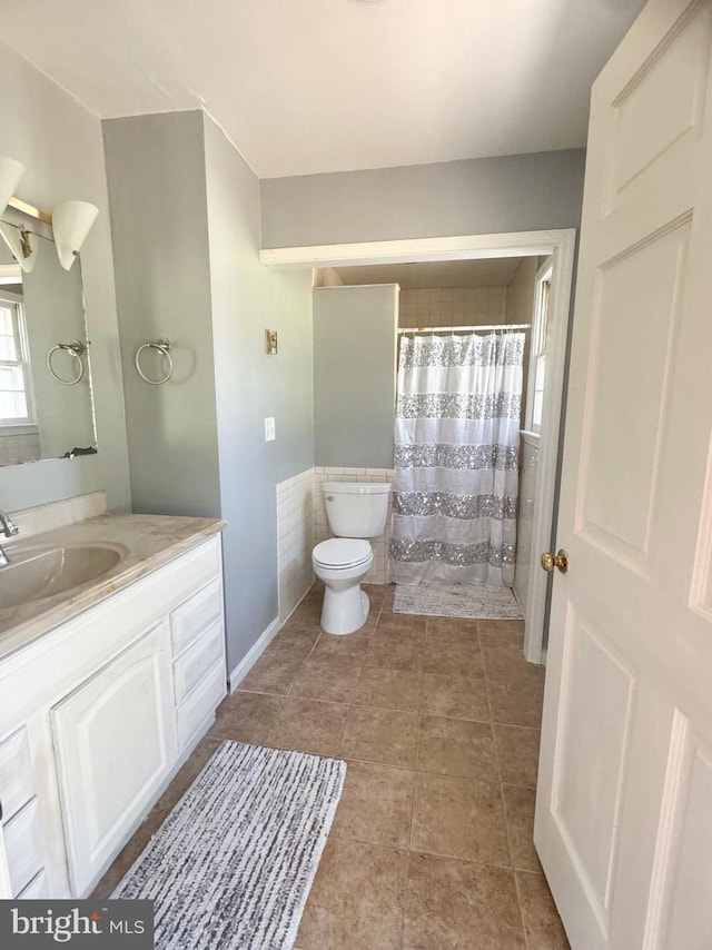 bathroom featuring vanity, toilet, and tile patterned flooring