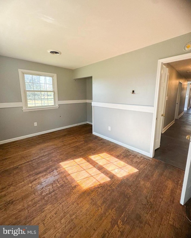 spare room with dark wood-type flooring