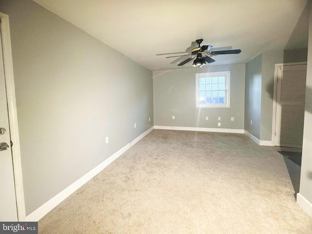 spare room featuring carpet flooring and ceiling fan