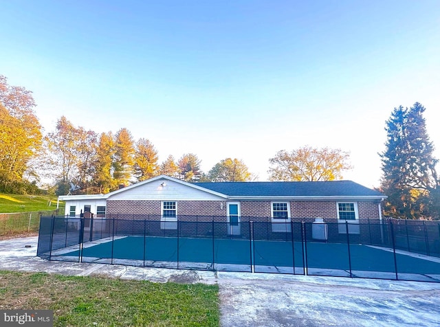 back of property featuring a swimming pool