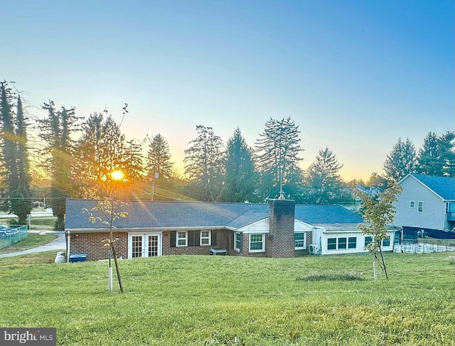 ranch-style house featuring a yard