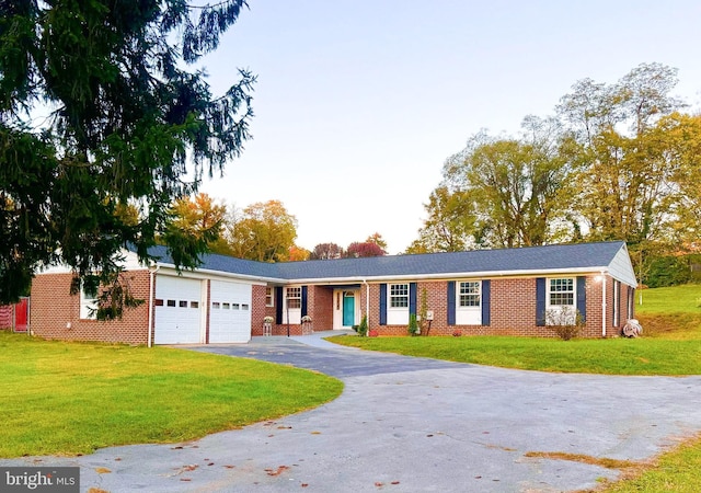 ranch-style home with a garage and a front lawn