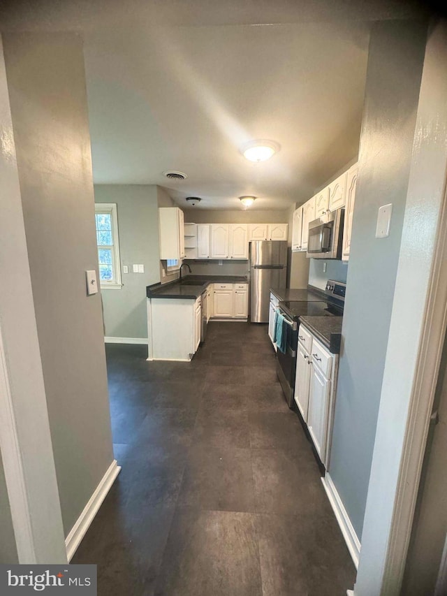 kitchen featuring white cabinets, stainless steel appliances, and sink