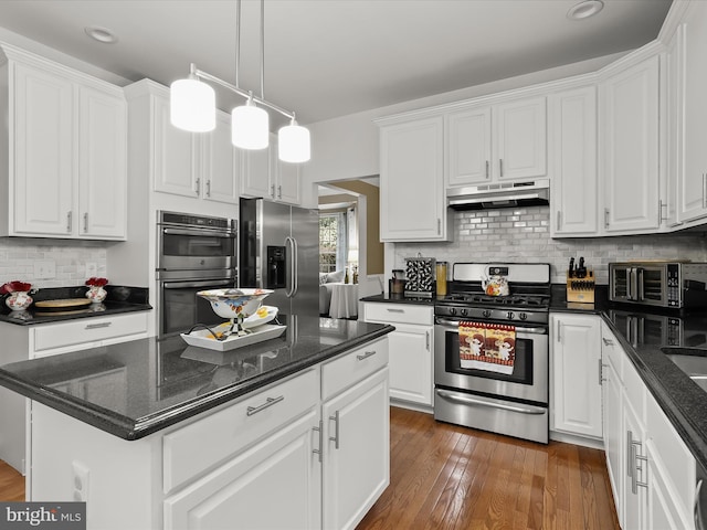 211 Glyndon Meadow Rd, Reisterstown, MD 21136 - kitchen with appliances with stainless steel finishes, under cabinet range hood, white cabinetry, hardwood / wood-style flooring, and recessed lighting