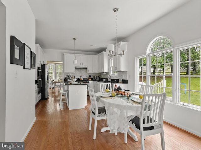 211 Glyndon Meadow Rd, Reisterstown, MD 21136 - dining space with light wood finished floors, baseboards, and a chandelier