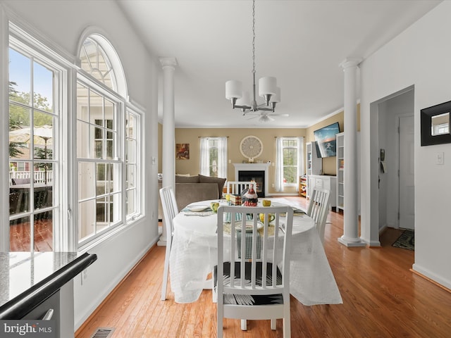 211 Glyndon Meadow Rd, Reisterstown, MD 21136 - dining space with ornate columns, wood finished floors, a chandelier, and baseboards