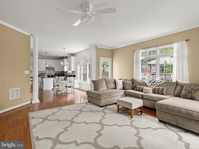 211 Glyndon Meadow Rd, Reisterstown, MD 21136 - living area with ornamental molding, a ceiling fan, wood finished floors, ornate columns, and baseboards