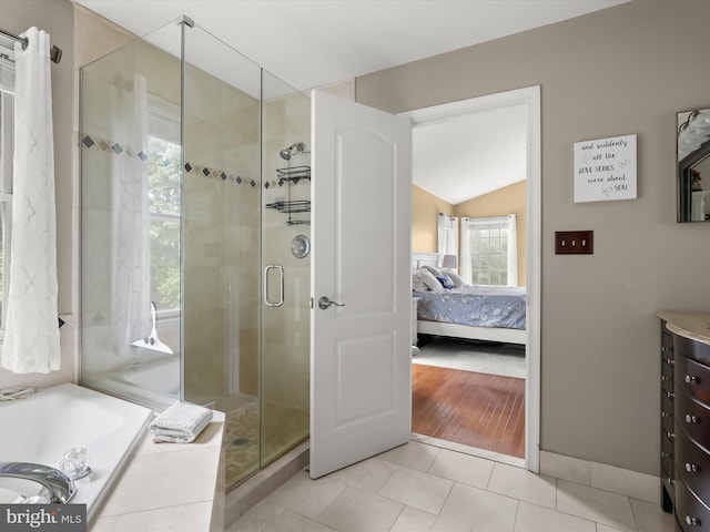 211 Glyndon Meadow Rd, Reisterstown, MD 21136 - ensuite bathroom featuring a shower stall, a garden tub, vanity, vaulted ceiling, and tile patterned flooring