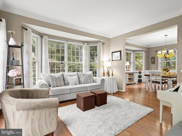 211 Glyndon Meadow Rd, Reisterstown, MD 21136 - living area featuring a chandelier, wood finished floors, plenty of natural light, and crown molding