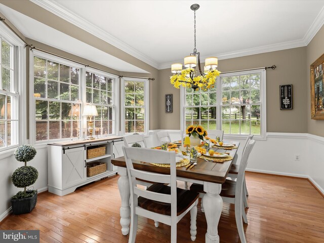 211 Glyndon Meadow Rd, Reisterstown, MD 21136 - dining room featuring a chandelier, light wood-style floors, crown molding, and baseboards