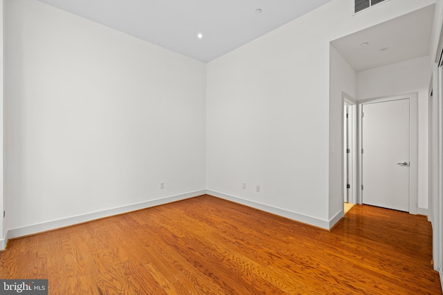 unfurnished room with hardwood / wood-style flooring