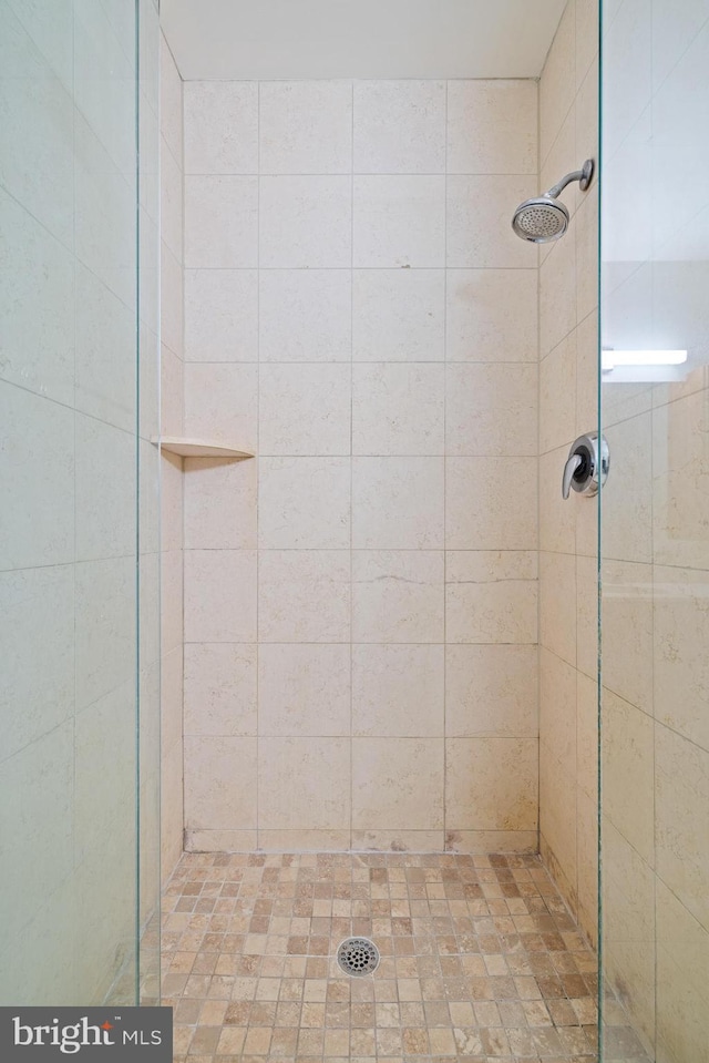 bathroom with tiled shower