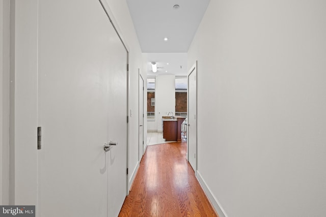 corridor featuring light hardwood / wood-style floors