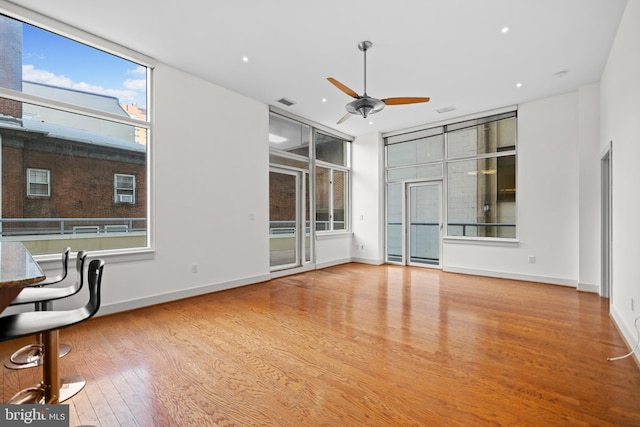 unfurnished living room featuring light wood-type flooring and ceiling fan