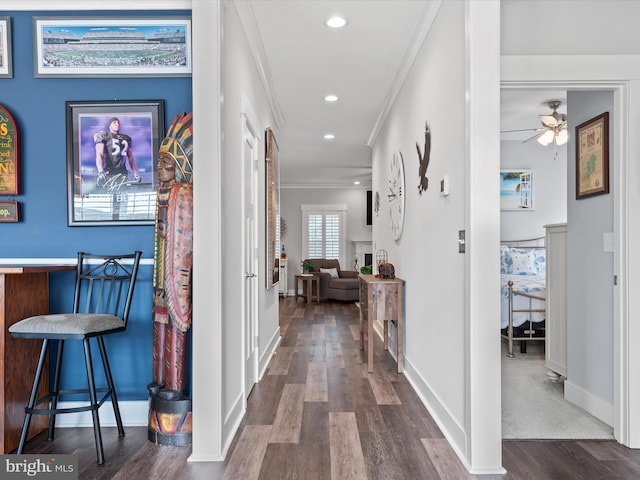 corridor featuring dark hardwood / wood-style floors and crown molding