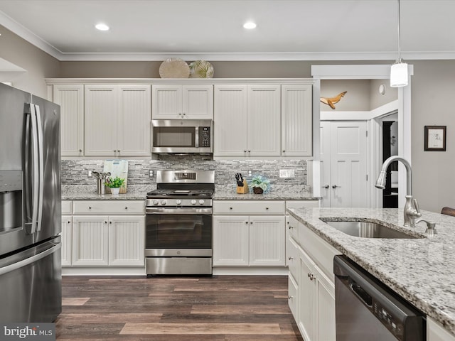 kitchen featuring white cabinets, stainless steel appliances, and hanging light fixtures