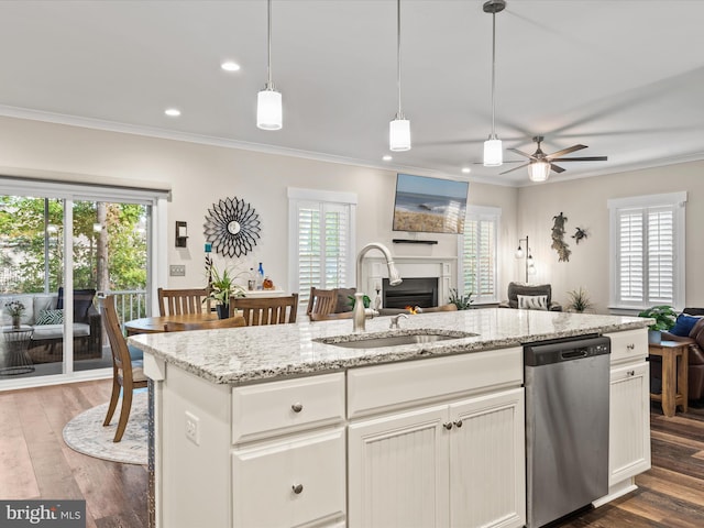 kitchen featuring dishwasher, sink, hanging light fixtures, ceiling fan, and dark hardwood / wood-style flooring