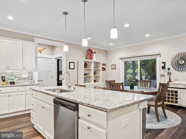 kitchen with dark hardwood / wood-style floors, stainless steel dishwasher, a kitchen island with sink, and sink