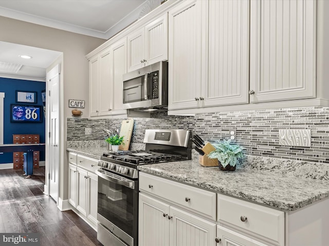 kitchen featuring tasteful backsplash, stainless steel appliances, crown molding, white cabinets, and dark hardwood / wood-style floors