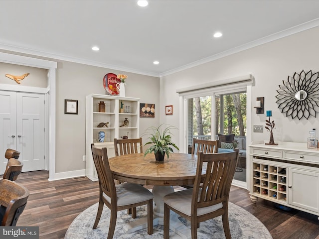 dining area with dark hardwood / wood-style floors and ornamental molding