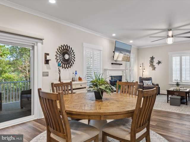 dining room featuring hardwood / wood-style flooring, plenty of natural light, and crown molding