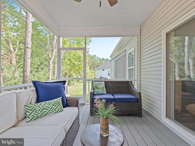 sunroom featuring ceiling fan and a wealth of natural light