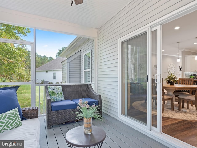 sunroom / solarium featuring ceiling fan