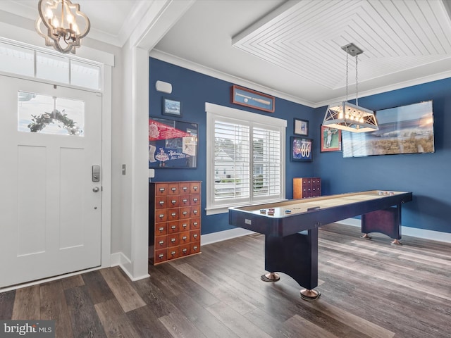 playroom with dark hardwood / wood-style flooring, a chandelier, and ornamental molding