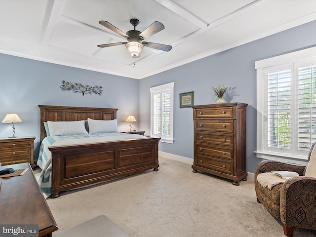 carpeted bedroom featuring ceiling fan and ornamental molding