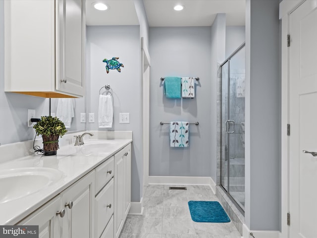 bathroom with vanity and a shower with shower door