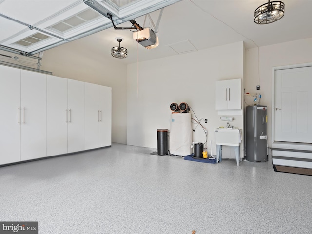 garage featuring sink, a garage door opener, and water heater