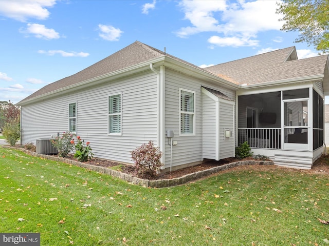 view of property exterior with a lawn, a sunroom, and central AC unit