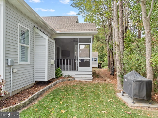 view of exterior entry featuring a yard