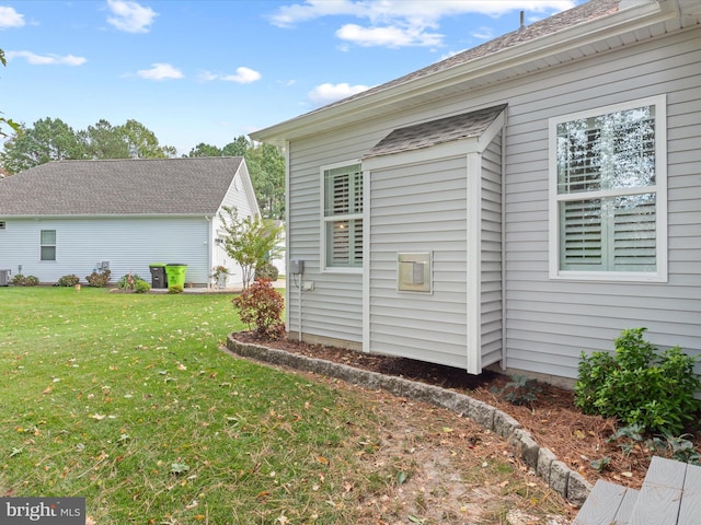 view of side of home featuring a lawn