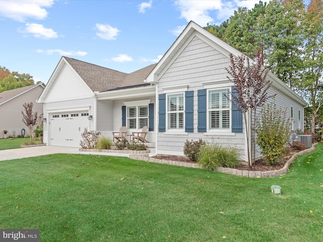 view of front of house with cooling unit, a garage, and a front yard