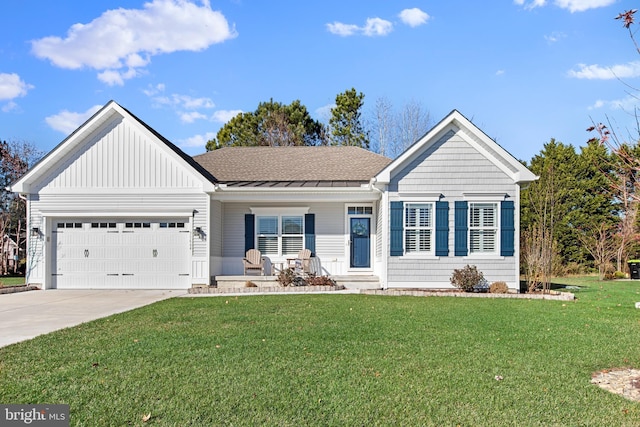 view of front facade featuring covered porch, a front yard, and a garage