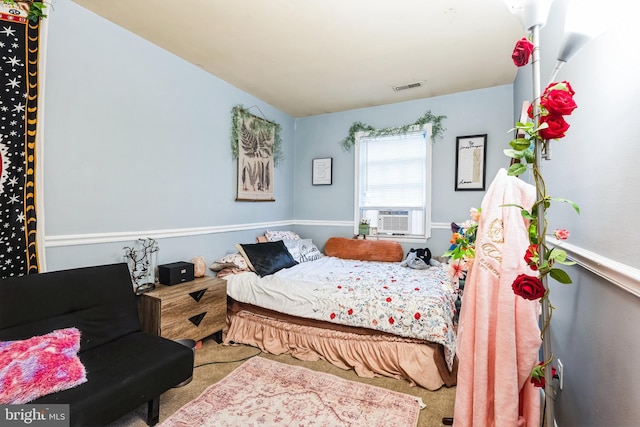 bedroom featuring cooling unit, visible vents, and carpet flooring