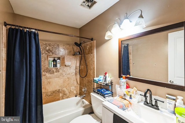 bathroom with visible vents, vanity, shower / bath combination with curtain, and toilet