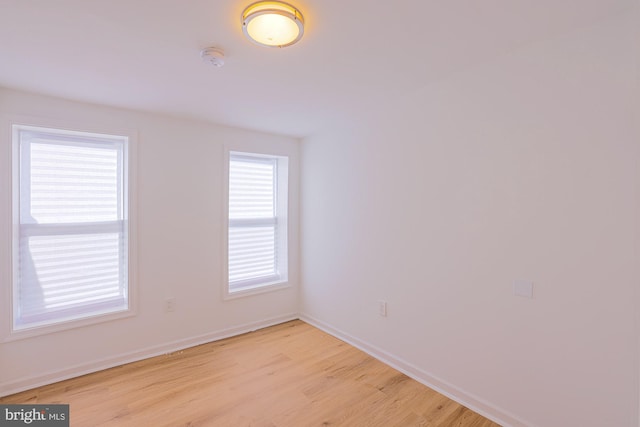 unfurnished room featuring a wealth of natural light and light hardwood / wood-style floors