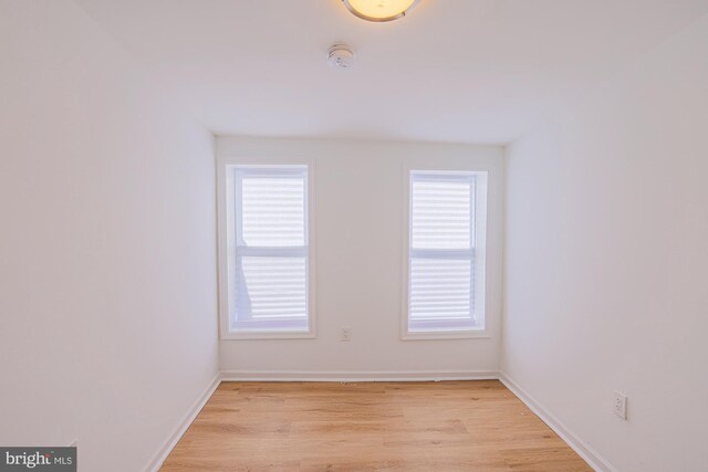 unfurnished room featuring light hardwood / wood-style floors and a wealth of natural light