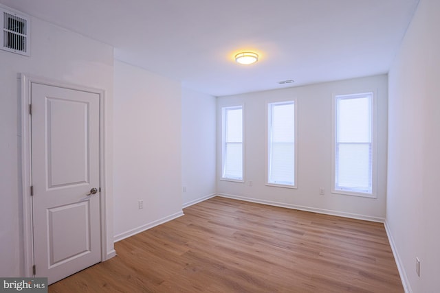 unfurnished room with light wood-type flooring