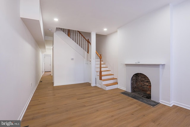 unfurnished living room with wood-type flooring