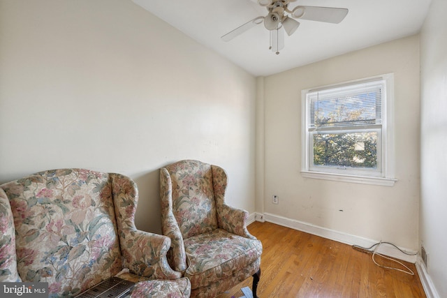 sitting room featuring light hardwood / wood-style floors and ceiling fan